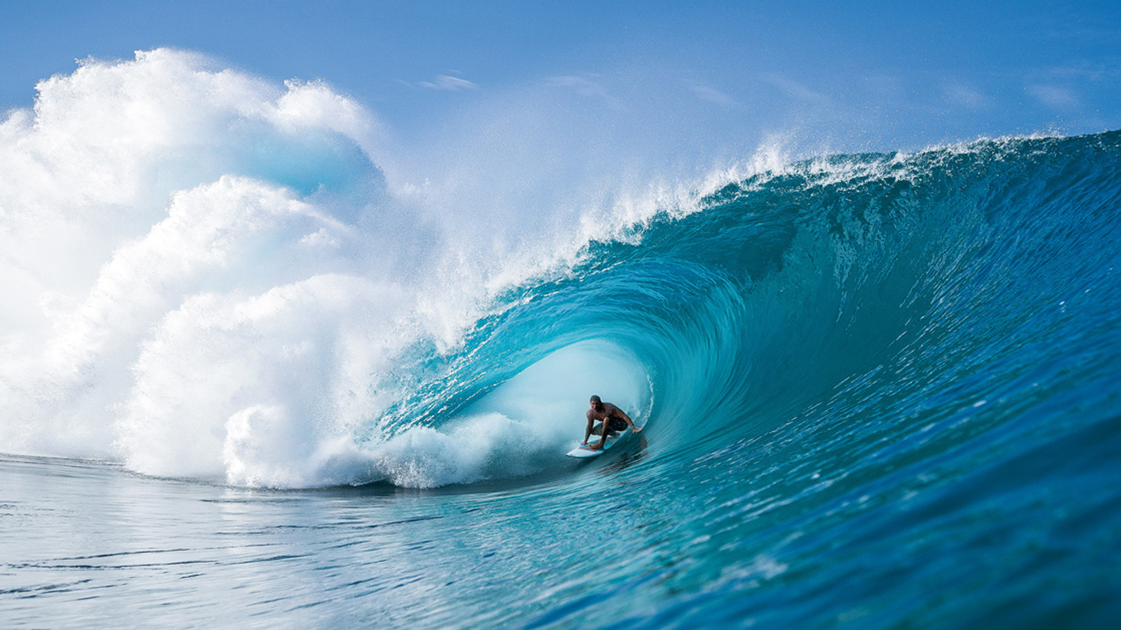  A surfer rides a large wave in the ocean.